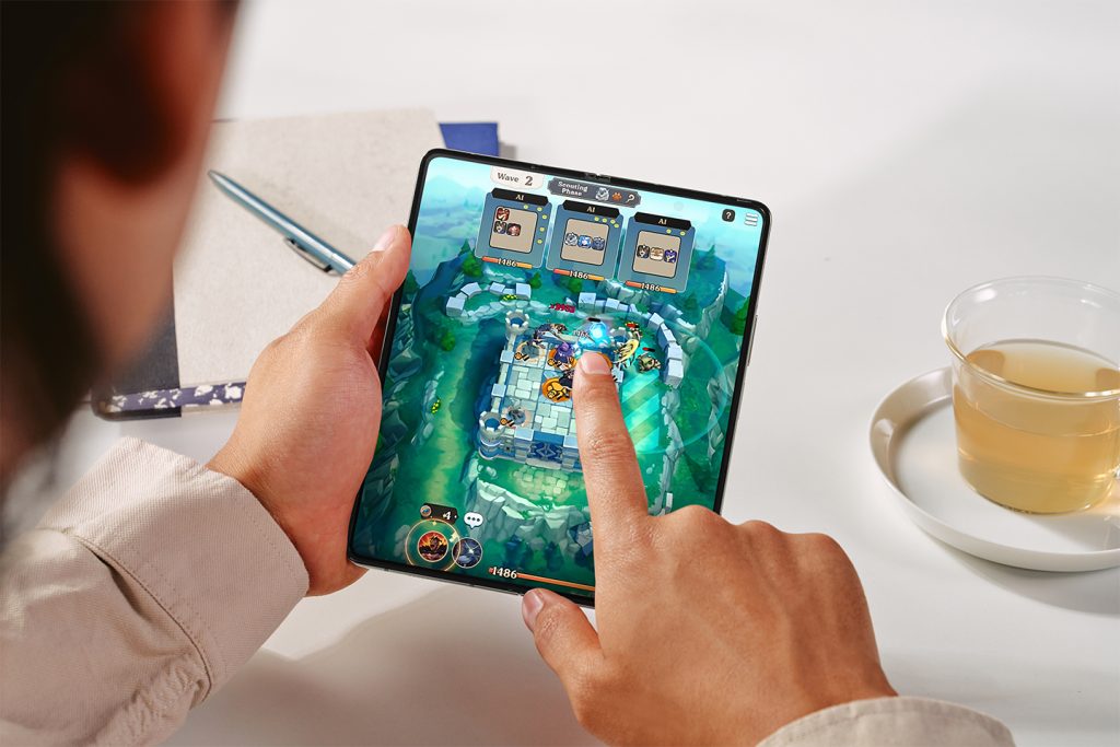 Photo of a person using a Samsung Galaxy Z Fold5 to play a game.